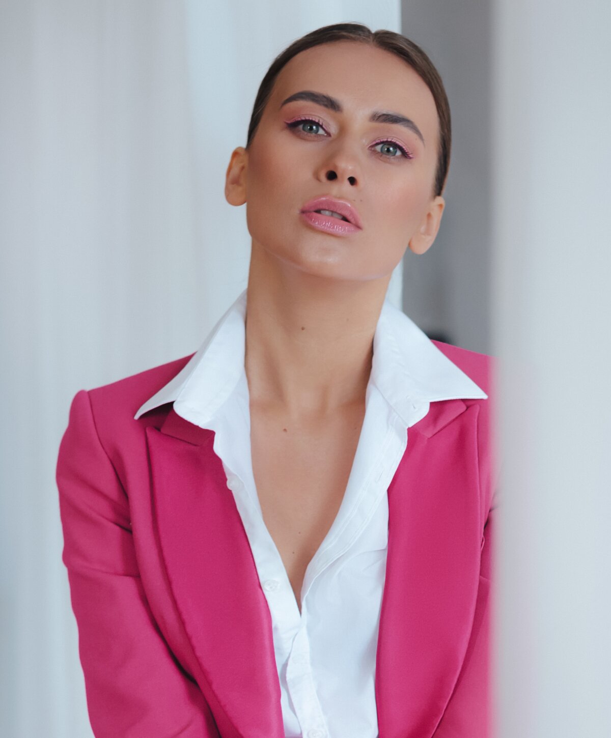 Westlake facelift model wearing a pink blazer